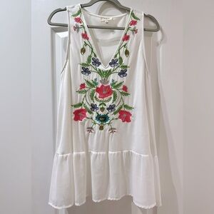Umgee Embroidered sleeveless top with ruffled hem.